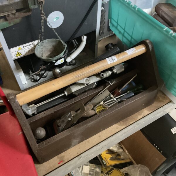 Vintage tool carry box filled with antique hand tools.