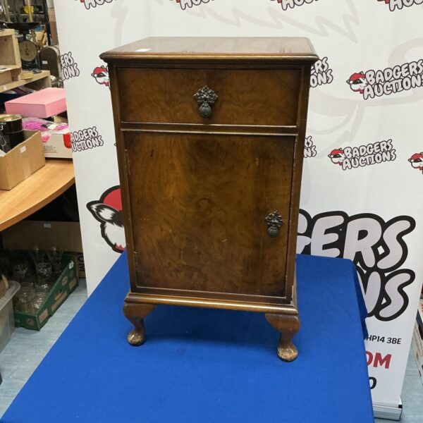 Vintage walnut cabinet with a single door, ideal for storage.