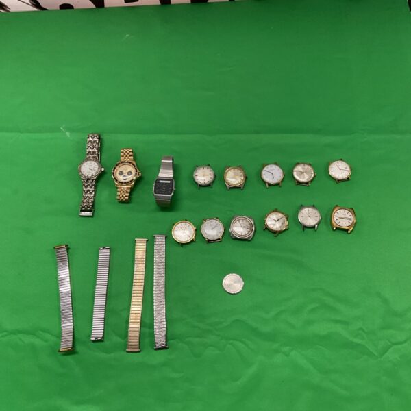 Vintage watch collection lot with spare straps for collectors.