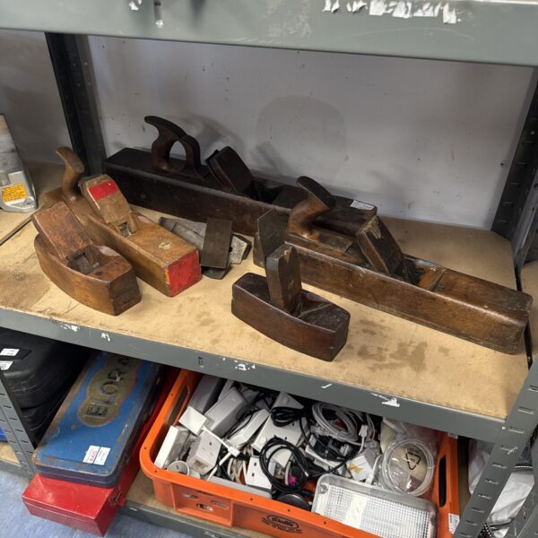 Selection of vintage wood planes and blades for woodworking.
