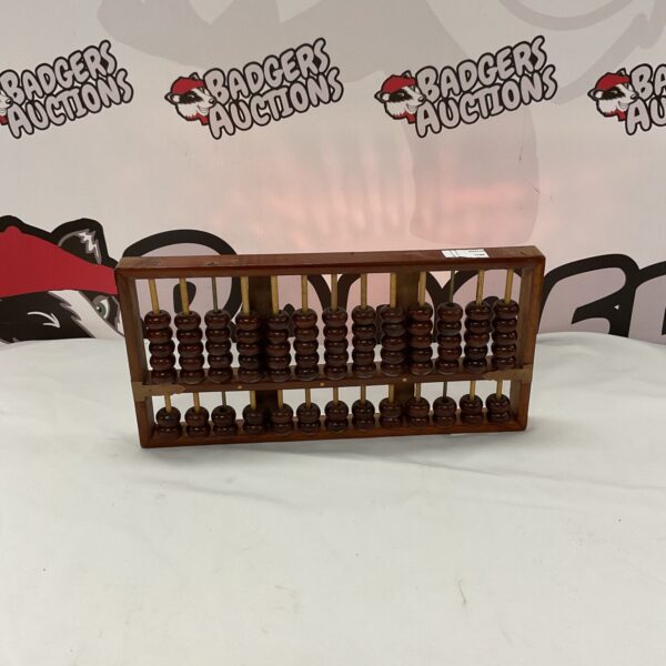 Vintage wooden abacus with rows of beads for calculation.