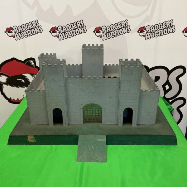 Front view of a vintage wooden castle toy.