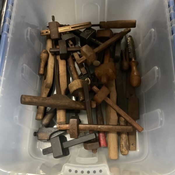 Vintage woodworking tools lot including planes and chisels.