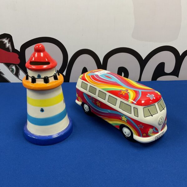 Colourful VW camper van and lighthouse ceramic moneybox pair.