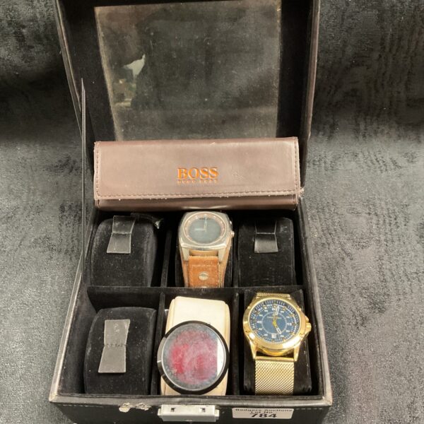 Watch lot featuring Fossil and Boss timepieces and a glasses case.