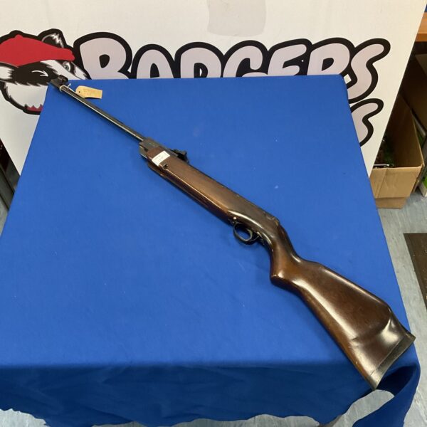 Vintage Webley Xocet .22 calibre break barrel air rifle on blue background.