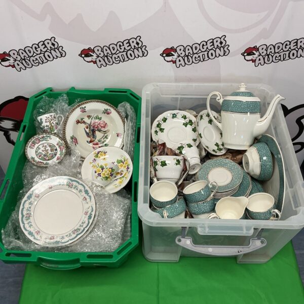 Two boxes of vintage Wedgwood and Colclough china teasets with floral patterns.