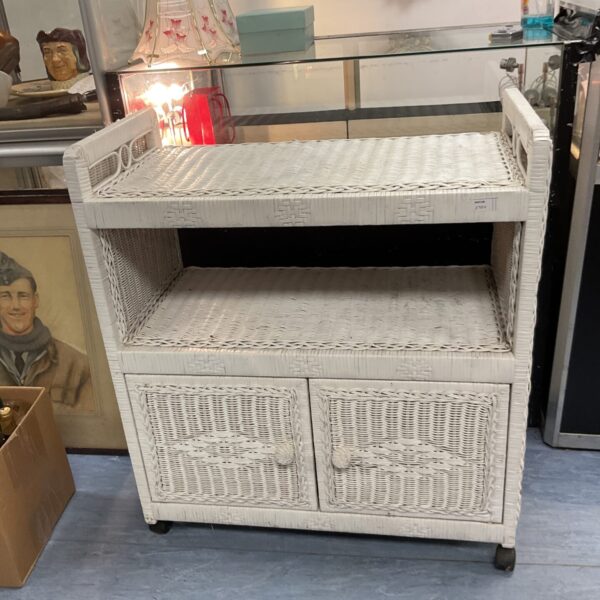 White rattan trolley cabinet with drawers and shelf.