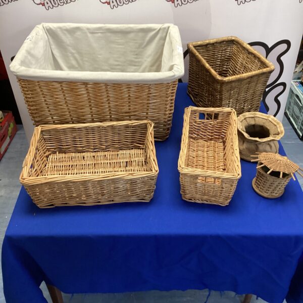 Lot of four vintage wicker baskets for storage and display.