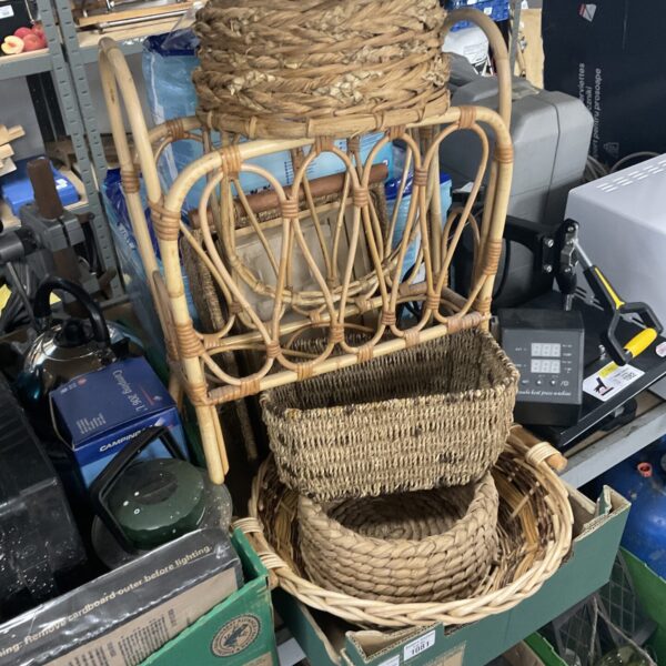 Vintage wicker baskets and newspaper rack for rustic home storage.