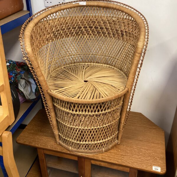 Vintage wicker conservatory chair with open weave design.
