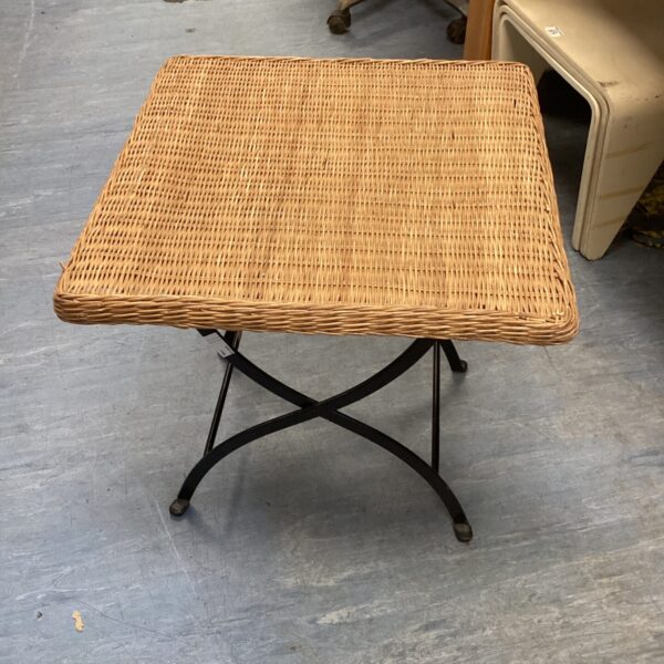 Vintage wicker table with metal frame for rustic home decor.