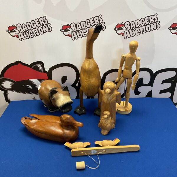 Vintage wooden animal figures including ducks and penguins.