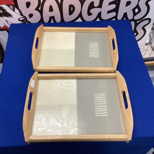 Set of two wooden serving trays with handles.
