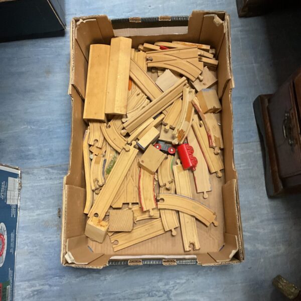 Vintage wooden train track set with various pieces.