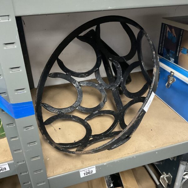 Vintage wrought iron flower basket bracket for garden or home display.