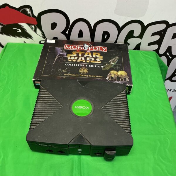Vintage Xbox console with Star Wars Monopoly game bundle.