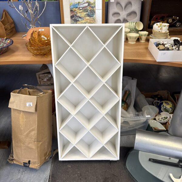 Wooden yarn storage rack with multiple cubbies for organisation.