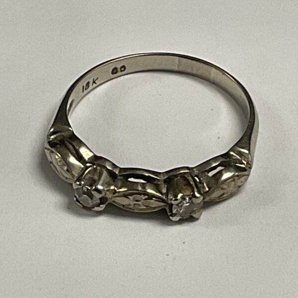 Elegant 18ct white gold ring with two diamonds, size O.