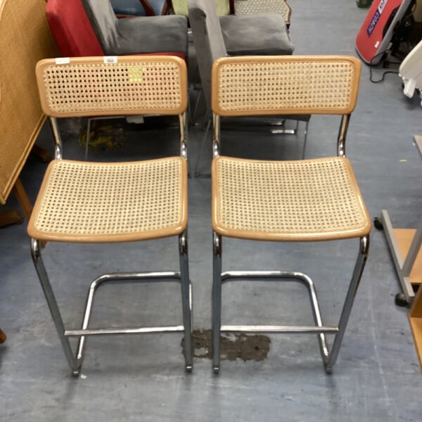 Vintage 1980s kitchen barstools with chrome and cane detailing.