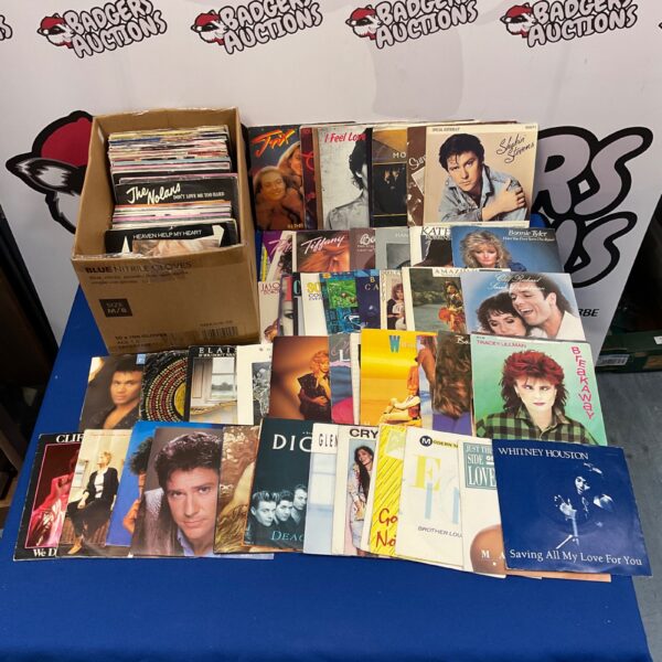 Collection of 7-inch vinyl singles including Whitney Houston and Bonnie Tyler.