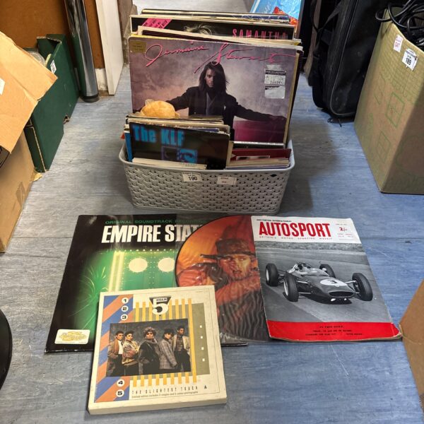 Mixed lot of 80s vinyl records in a basket.