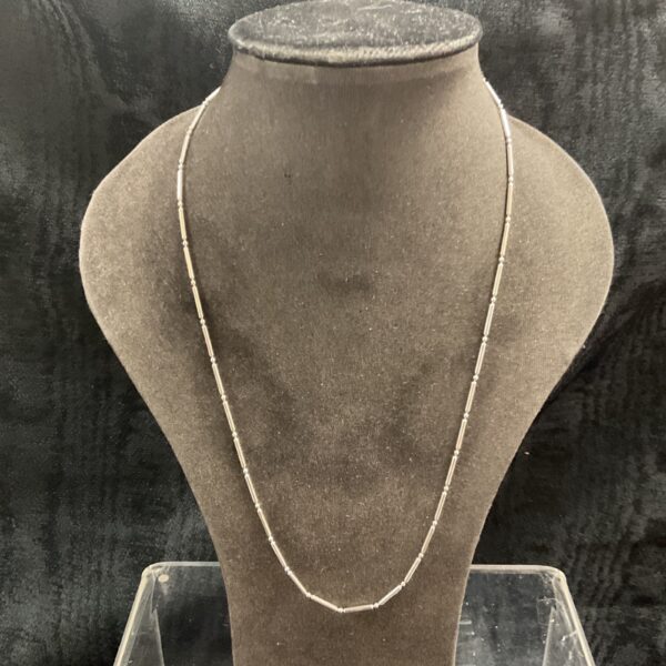 Delicate 925 silver bar link necklace on a display bust.