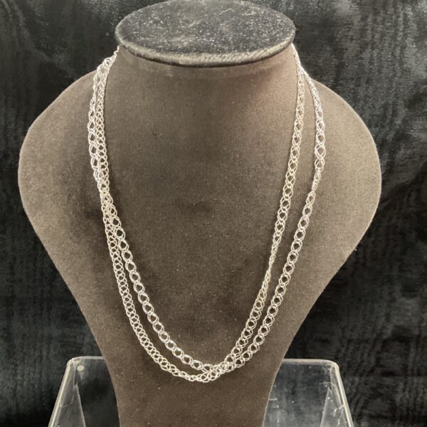Two 925 silver double link chain necklaces on a display bust.