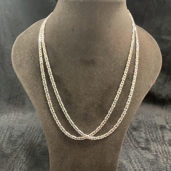 Two 925 silver Figaro necklaces on a display stand.