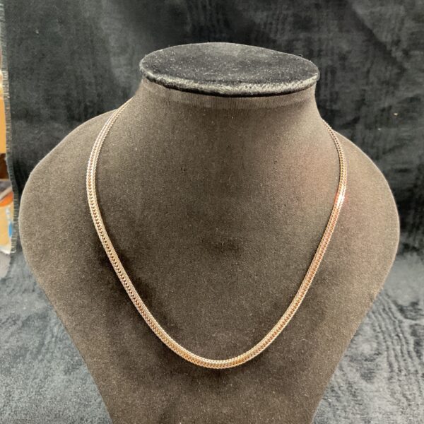 Delicate 925 silver flat link necklace on a display.