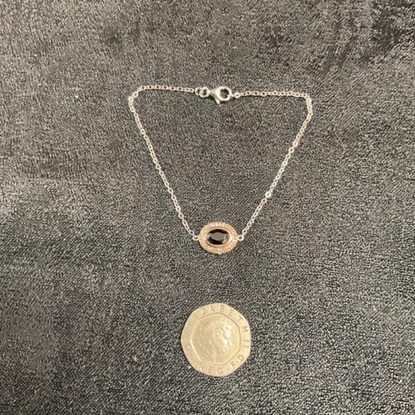 Delicate 925 silver bracelet with a red stone setting.