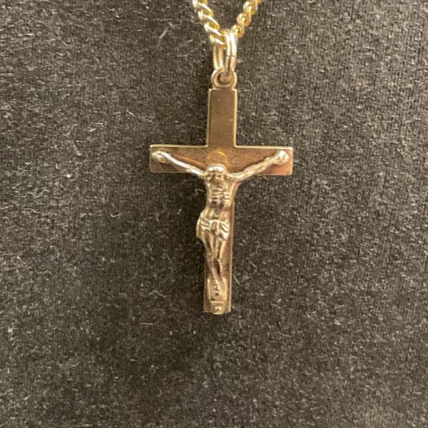 Detailed 9ct gold crucifix pendant by E J ltd on a necklace.