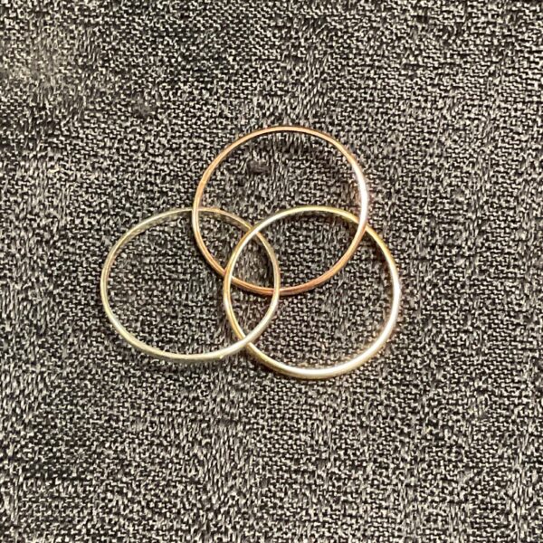 Close-up of a 9ct gold tri-colour puzzle ring.
