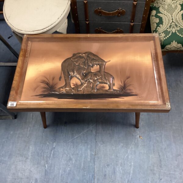 Close-up of the African elephant copper and glass coffee table.