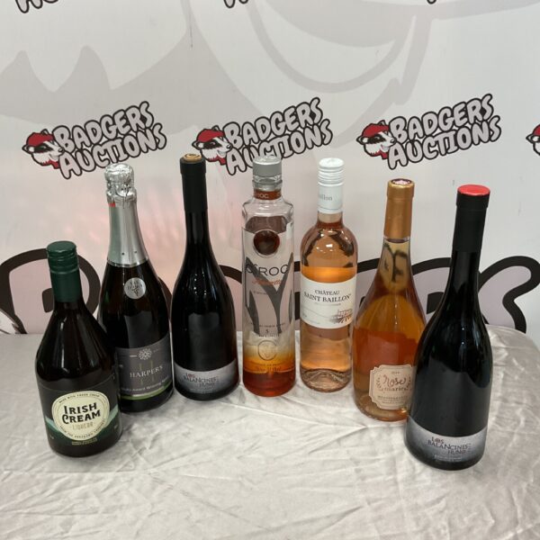 Collection of alcohol bottles including Ciroc, Amaretto, and Chateau Saint Baillon.