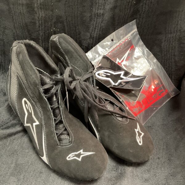 Pair of black Alpinestars race boots with original tags.