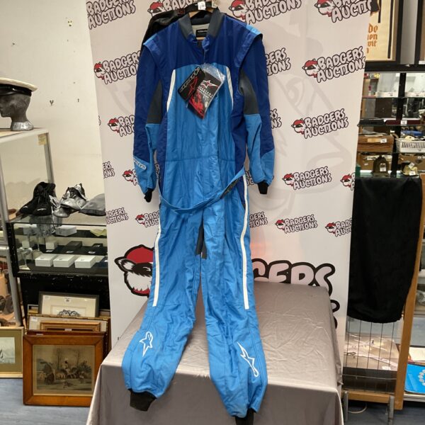 Full view of blue Alpinestars race suit on display.
