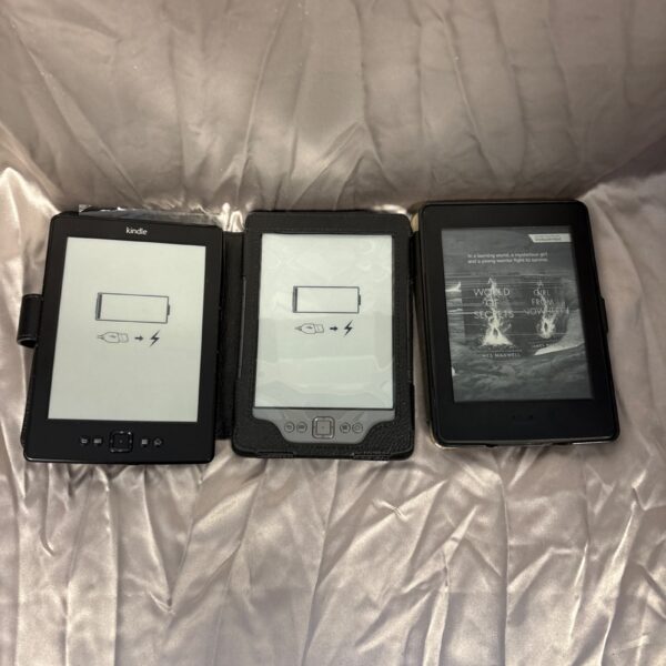 Lot of three Amazon Kindle e-readers for digital reading.