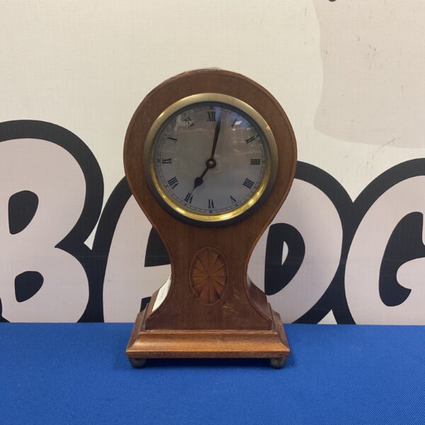 Antique balloon mantle clock with Roman numeral dial.