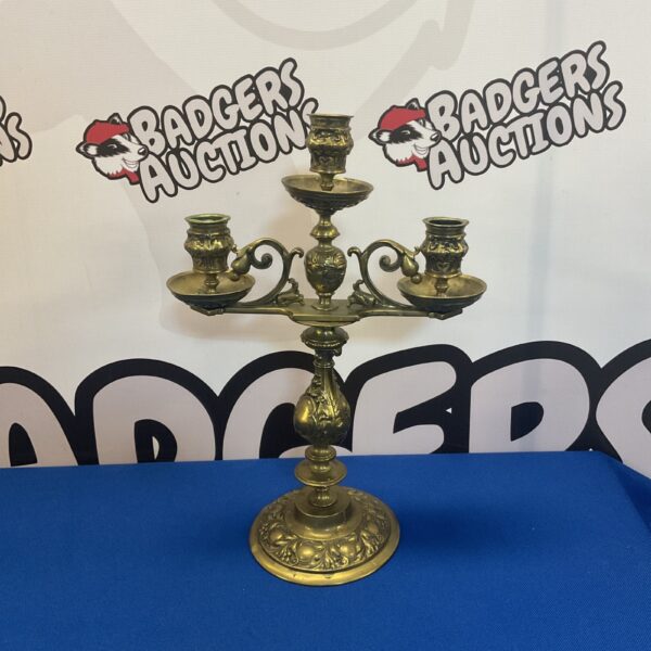 Ornate antique brass Baroque candelabra with three arms.