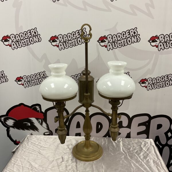 Antique brass student oil lamp with clear glass shades.