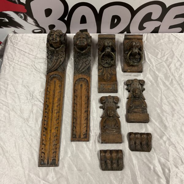 Antique carved oak terminals with angel and lion details.