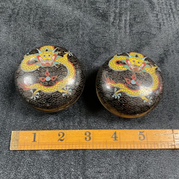 Antique Chinese cloisonne pots with a vibrant dragon motif.