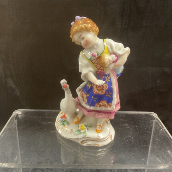Antique German porcelain figurine of a farm girl with baby and goose.