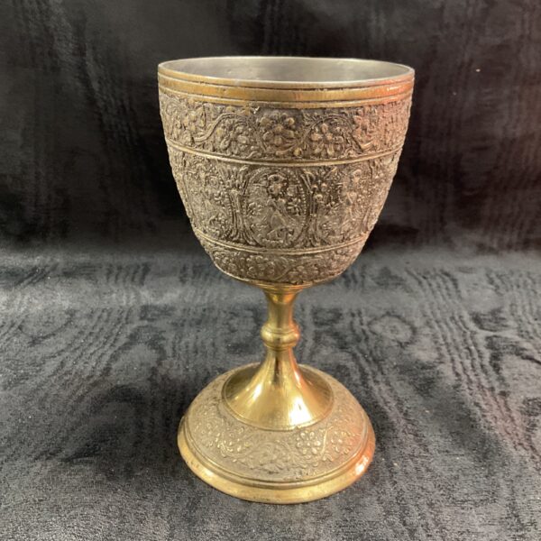 Antique Indian chalis with intricate embossed detailing.