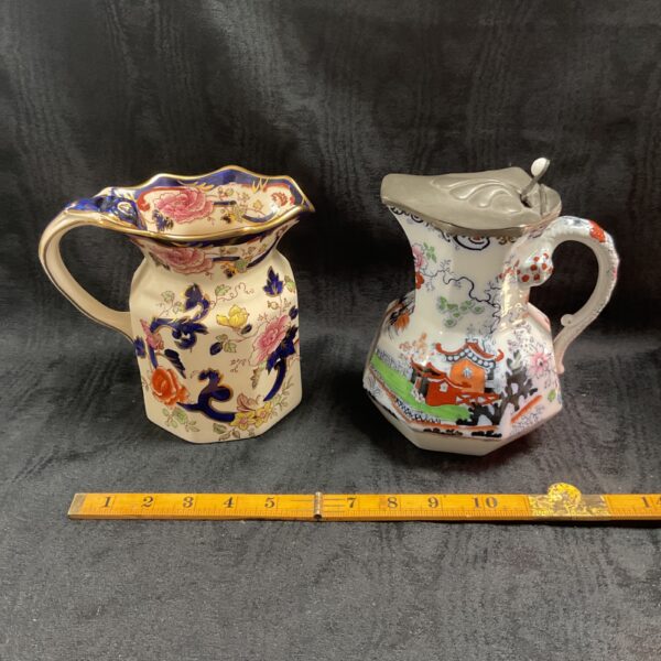 Pair of antique Staffordshire Mason jugs with transferware designs.