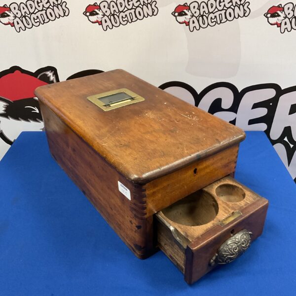 Side view of antique oak cash register with drawer extended.