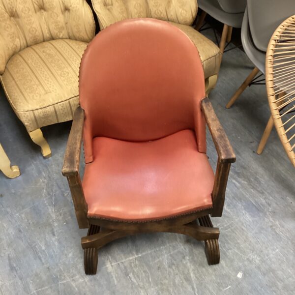 Antique oak chair with leather seat and cross frame.
