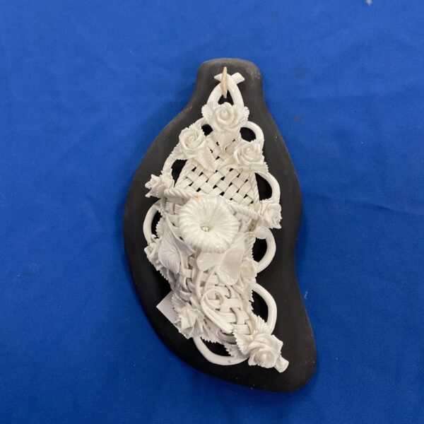 Antique parian china wall pocket with woven floral design.