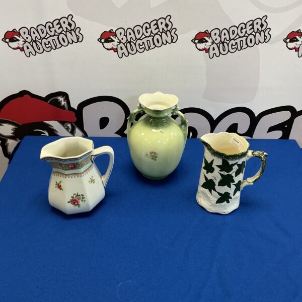 Antique porcelain jugs and vase with floral decoration.